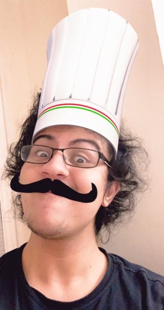 Toaster wearing a chef hat and mustache.